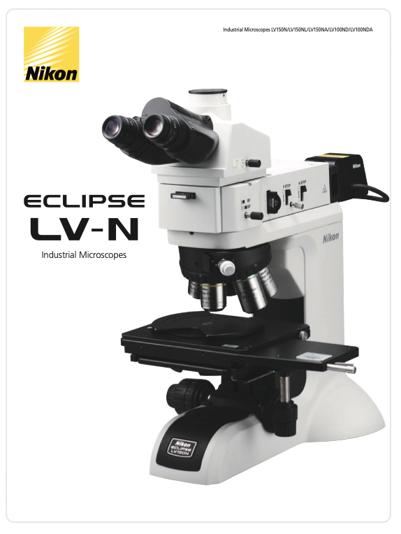 A white and black microscope
Description automatically generated